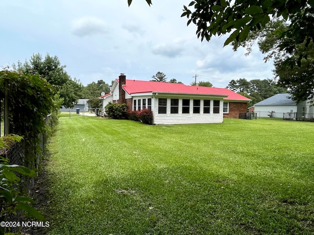 rear view of property featuring a lawn