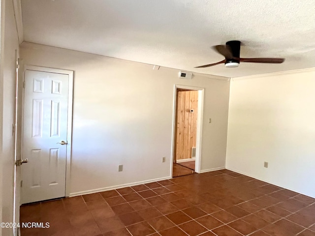 tiled spare room featuring a textured ceiling and ceiling fan