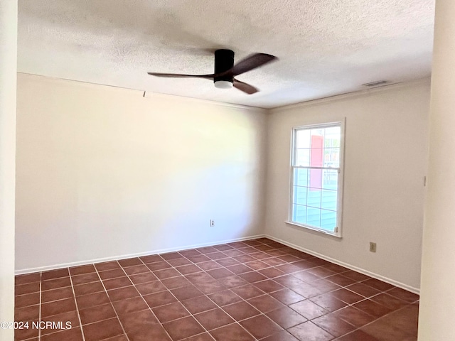 tiled spare room featuring ornamental molding, ceiling fan, and a textured ceiling