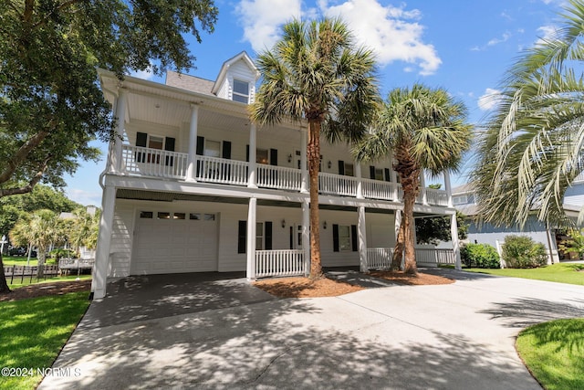 view of front facade featuring a garage, driveway, and a balcony