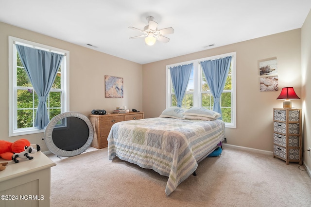 bedroom with light colored carpet and ceiling fan