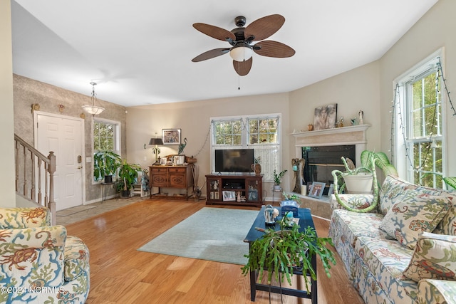 living room featuring light wood-type flooring and ceiling fan