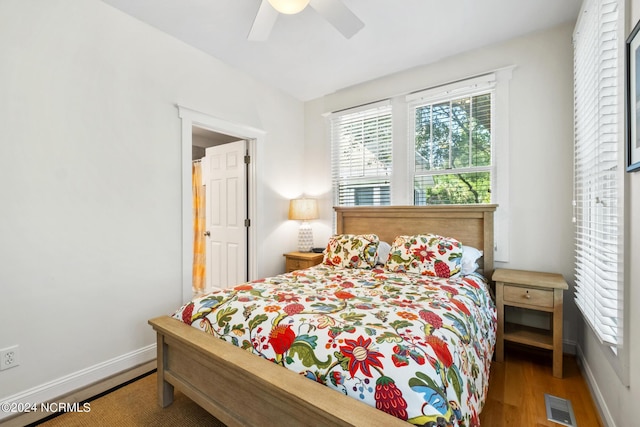 604 Currituck Way, Bald Head Island, NC 28461 - bedroom featuring multiple windows, wood finished floors, and ceiling fan