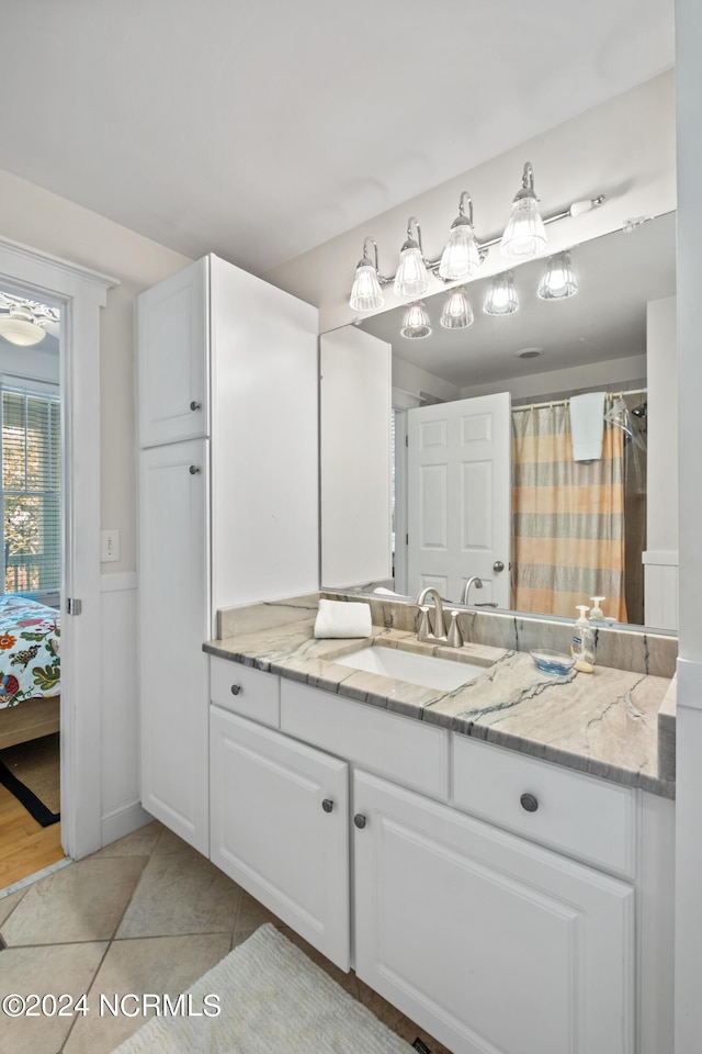 604 Currituck Way, Bald Head Island, NC 28461 - full bathroom featuring vanity, wainscoting, ensuite bathroom, and tile patterned floors