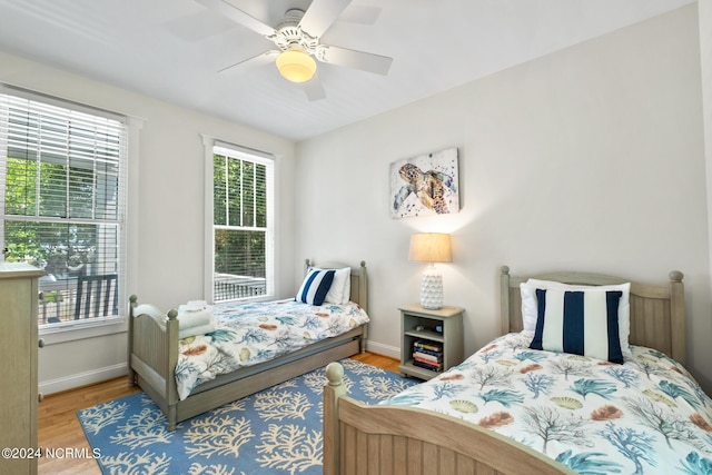 604 Currituck Way, Bald Head Island, NC 28461 - bedroom with multiple windows, wood finished floors, and a ceiling fan