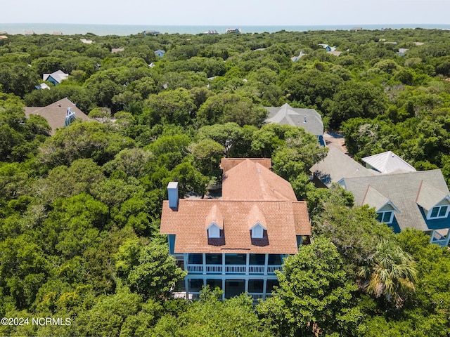 drone / aerial view featuring a wooded view