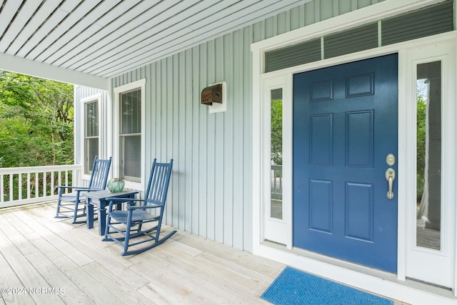 604 Currituck Way, Bald Head Island, NC 28461 - view of exterior entry with covered porch and board and batten siding