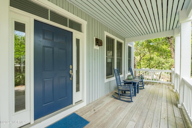 604 Currituck Way, Bald Head Island, NC 28461 - view of exterior entry featuring a porch and board and batten siding