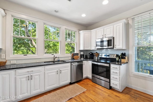 604 Currituck Way, Bald Head Island, NC 28461 - kitchen featuring stainless steel appliances, white cabinets, backsplash, dark stone countertops, and recessed lighting