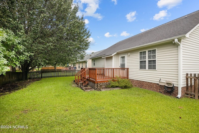 exterior space featuring a deck and a lawn