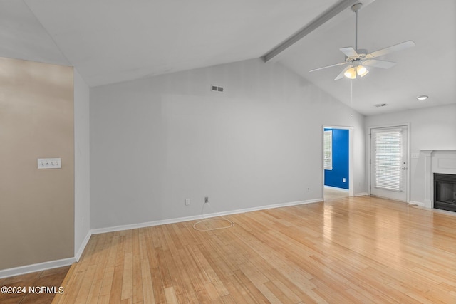 unfurnished living room with high vaulted ceiling, beamed ceiling, light wood-type flooring, and ceiling fan