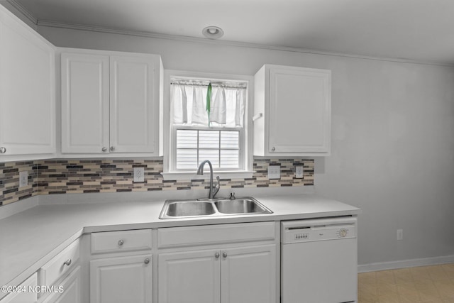 kitchen featuring sink, white cabinets, and white dishwasher