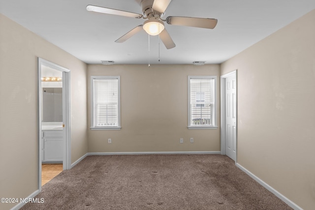 carpeted empty room with ceiling fan