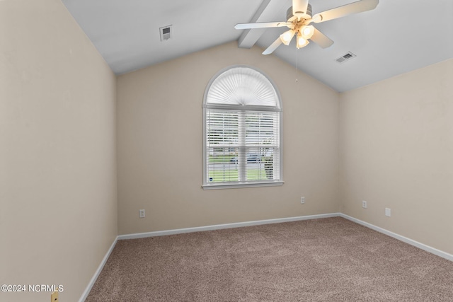 spare room featuring lofted ceiling with beams, carpet floors, and ceiling fan