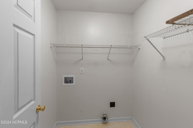 laundry area featuring hookup for an electric dryer, hookup for a washing machine, and light tile patterned floors