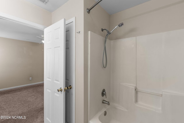 bathroom with shower / washtub combination and ceiling fan