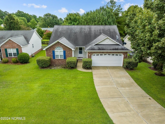 view of front of property featuring a garage and a front lawn