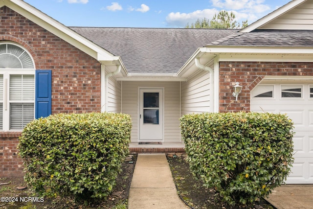 view of exterior entry with a garage