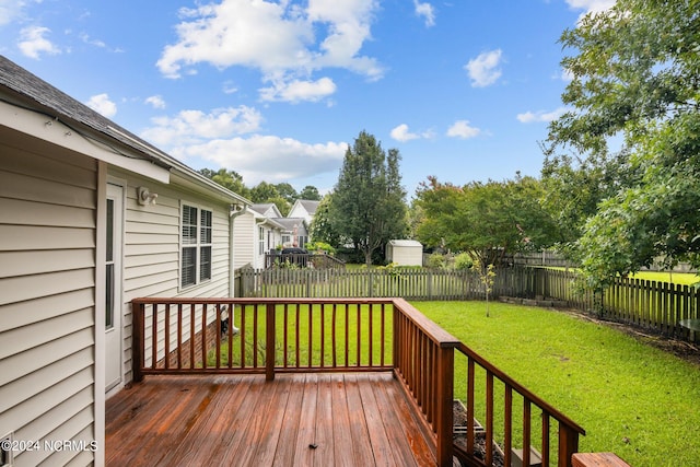 wooden terrace with a yard and a storage shed