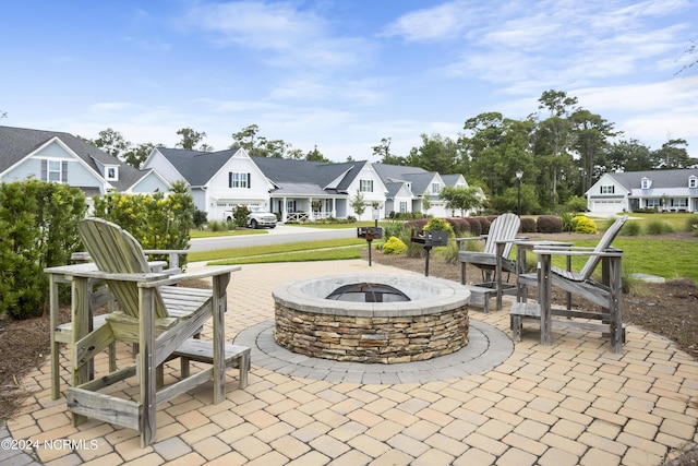 view of patio / terrace featuring an outdoor fire pit and a residential view