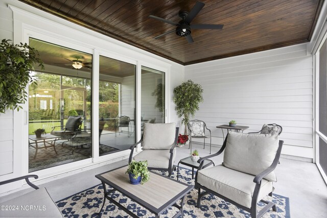 sunroom / solarium featuring ceiling fan and wood ceiling