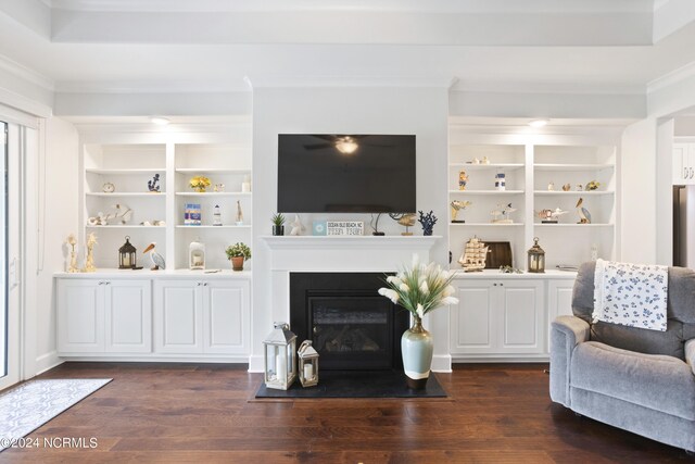 living room featuring built in features, ornamental molding, and wood-type flooring