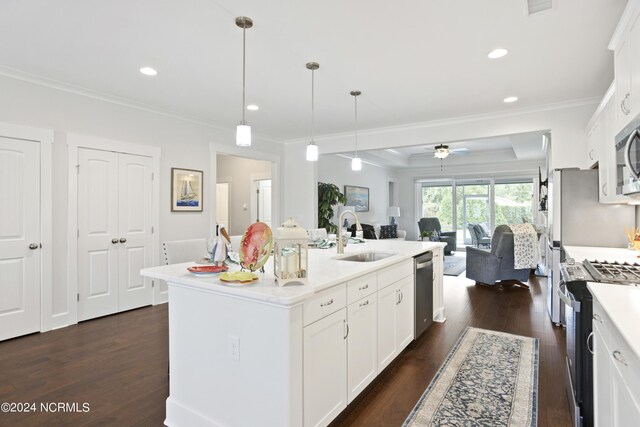 kitchen featuring dark hardwood / wood-style floors, appliances with stainless steel finishes, a kitchen island with sink, white cabinets, and sink