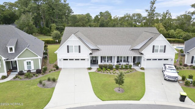 view of front of home with a front yard and a garage