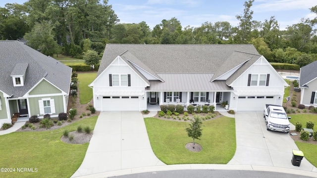 view of front of house with a front lawn, driveway, and an attached garage