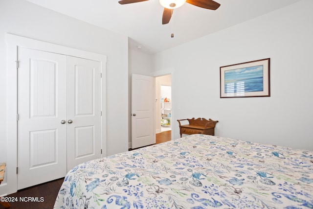 bedroom featuring ceiling fan, a closet, and dark hardwood / wood-style floors