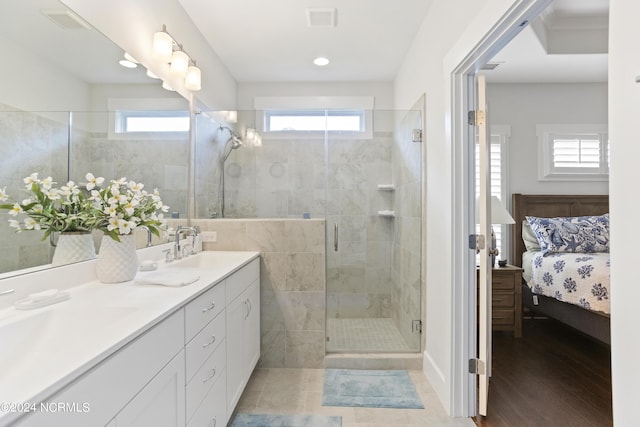 ensuite bathroom with a stall shower, plenty of natural light, ensuite bath, and visible vents