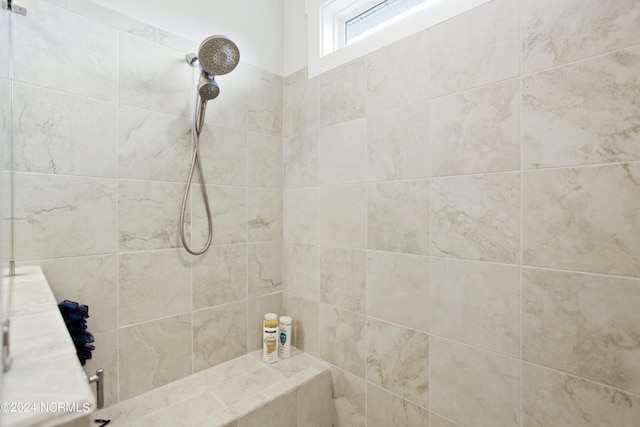 bathroom with a tile shower