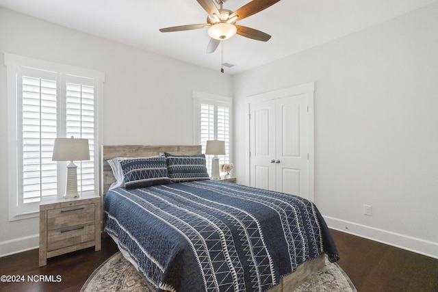 bedroom with ceiling fan, a closet, wood finished floors, and baseboards