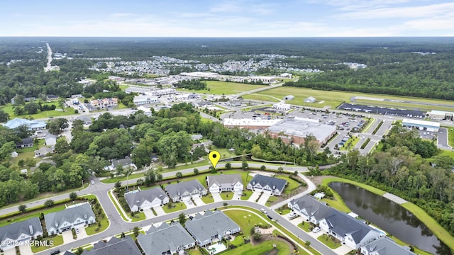 birds eye view of property featuring a water view and a residential view