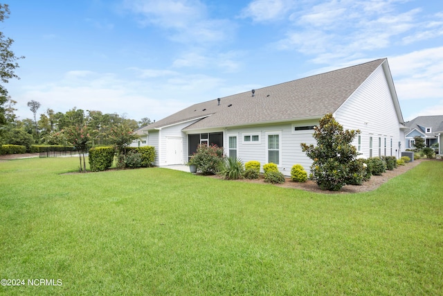 rear view of property featuring a yard