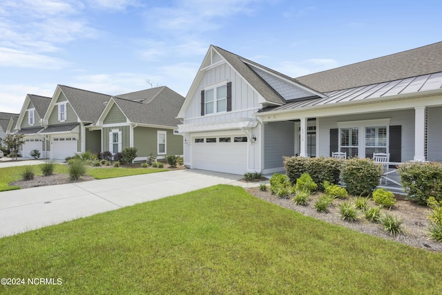 view of front of home featuring an attached garage, board and batten siding, a standing seam roof, driveway, and a front lawn