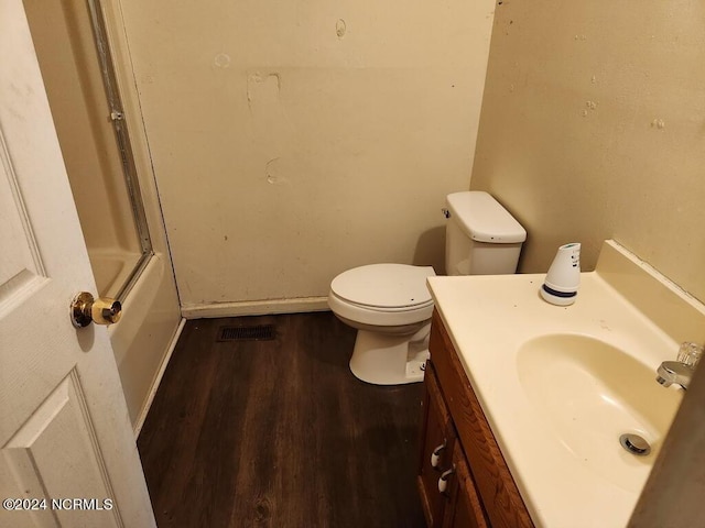 bathroom with vanity, hardwood / wood-style flooring, and toilet