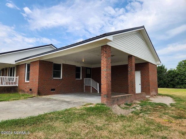 view of front of property with a front yard and a carport