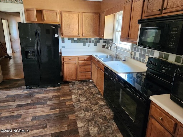 kitchen with sink, backsplash, black appliances, and dark hardwood / wood-style floors