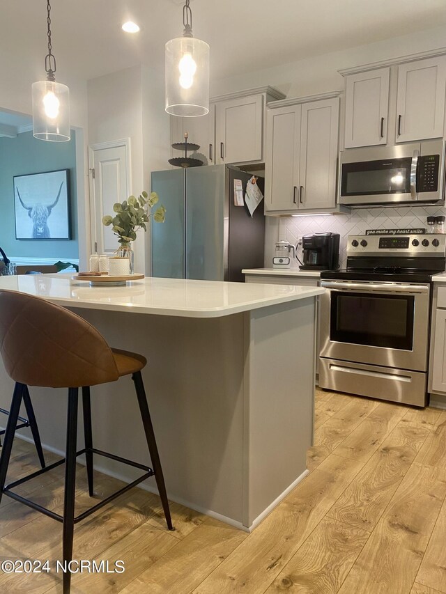 kitchen featuring lofted ceiling, ceiling fan, stainless steel dishwasher, a fireplace, and sink