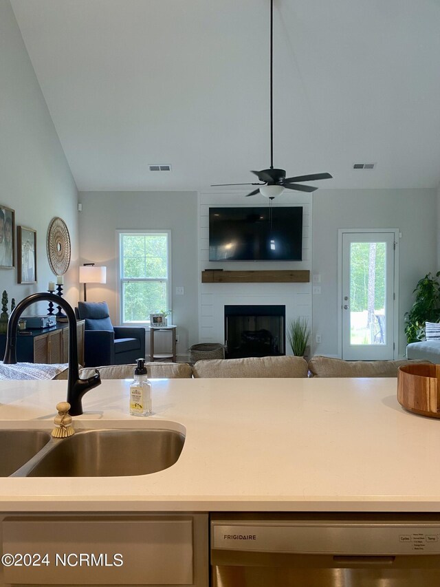 sitting room with lofted ceiling, hardwood / wood-style flooring, and a large fireplace