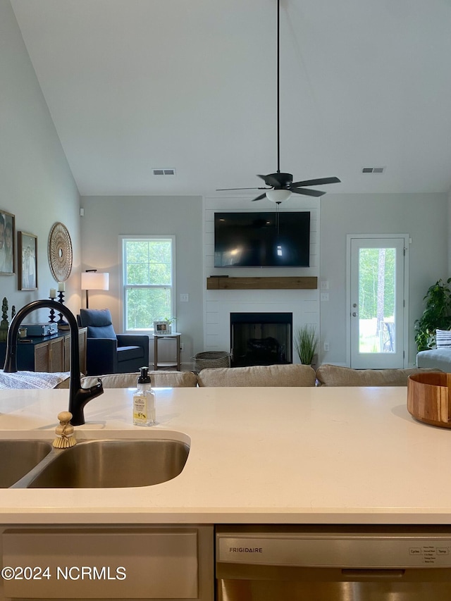 kitchen featuring light countertops, visible vents, open floor plan, a sink, and dishwasher