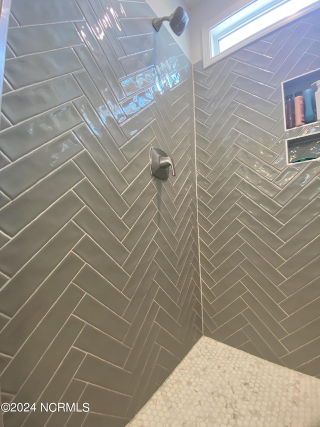 bathroom with a tile shower