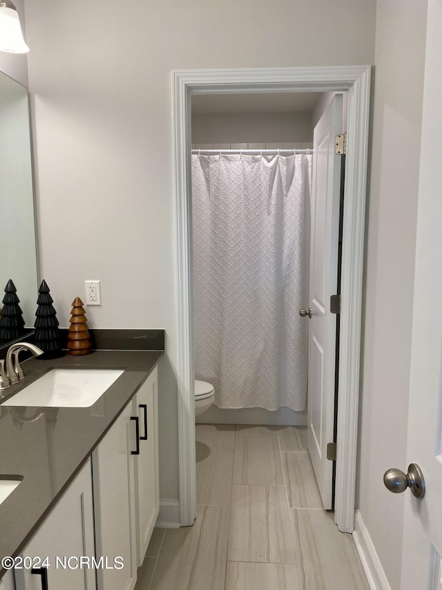 bathroom featuring toilet, shower / bath combo, and vanity