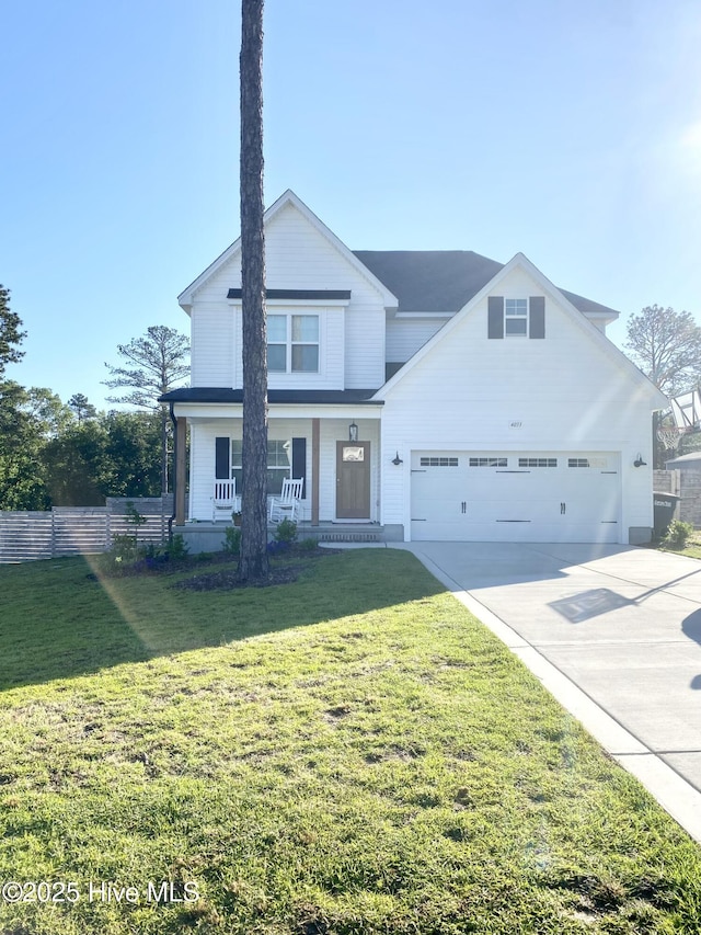 view of front of house with covered porch, a front yard, fence, a garage, and driveway