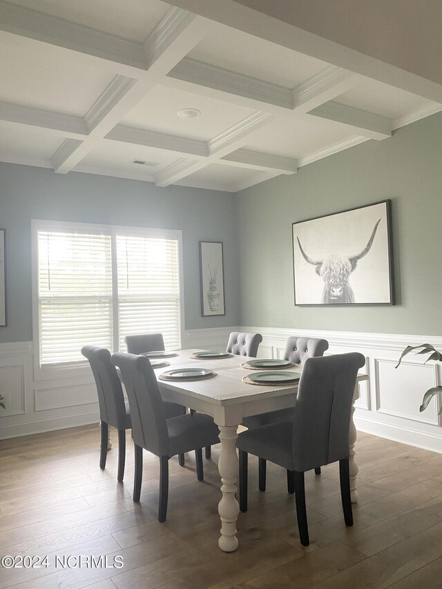 entrance foyer with ornamental molding, coffered ceiling, hardwood / wood-style flooring, and a healthy amount of sunlight