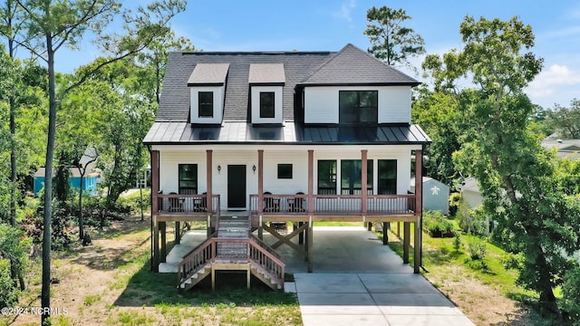 view of front of property featuring a carport and covered porch