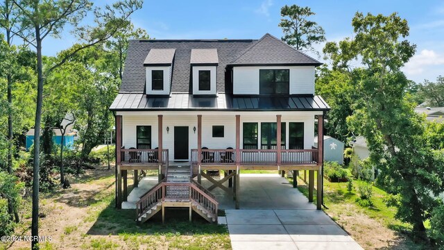 view of front of home featuring a carport and covered porch