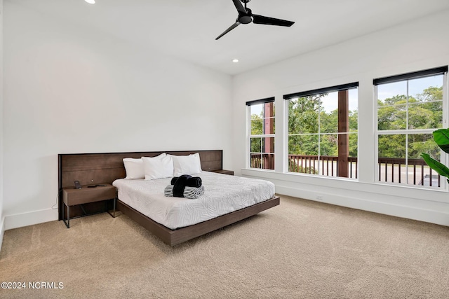 bedroom featuring light colored carpet and ceiling fan