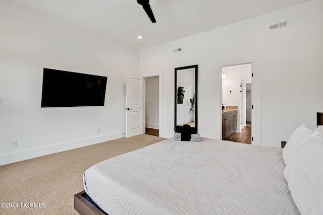 carpeted bedroom featuring ceiling fan and ensuite bath